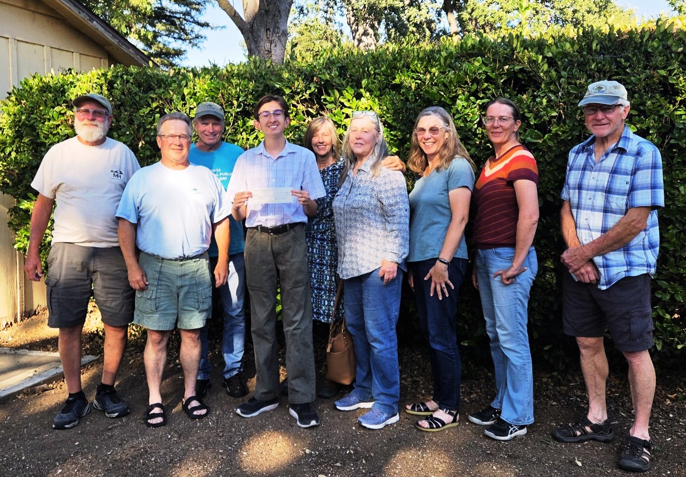 Gabriel accepting his check from ALPS board members.